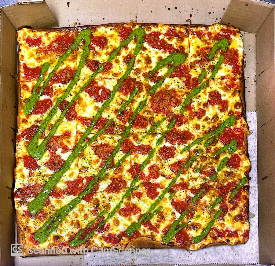 Little Italy square Grandma pizza with basil pesto drizzle